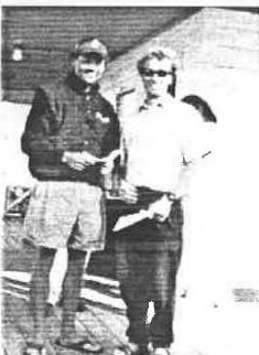 John Clark and Martin Shaw standing on a deck holding their prizes