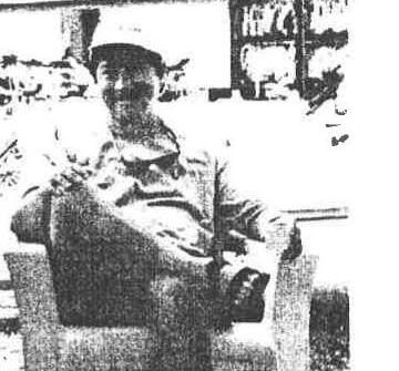Commodore Gord Chu sitting in a lawn chair outdoors