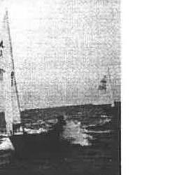 Two Albacore dinghies sailing, one with sail flying a spinnaker-like jib