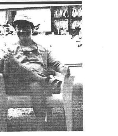 Commodore Gord Chu sitting in a lawn chair outdoors