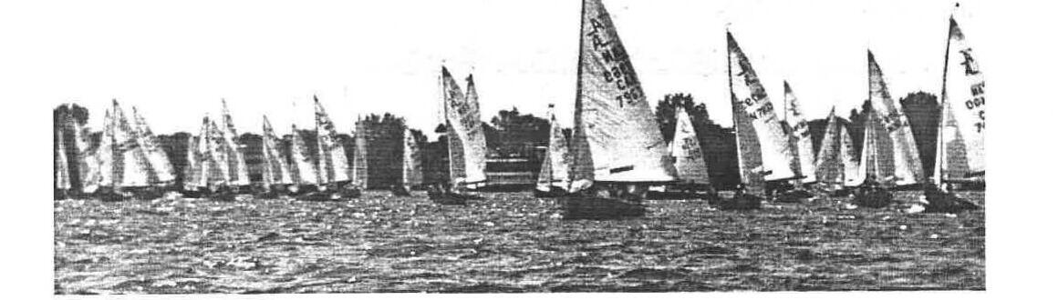 A tightly packed fleet of Albacores racing upwind, sails overlapping