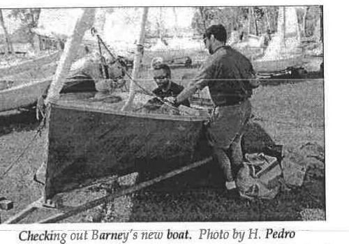 Three people checking out Barney Harris's new wooden Albacore at Mooredale Sailing Club. Photo by H. Pedro