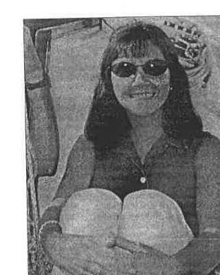 Commodore Heather Macnaughton smiling, wearing sunglasses