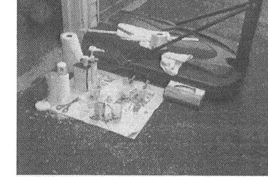 Epoxy resin, hardener, and mixing tools laid out ahead of the fiberglass work