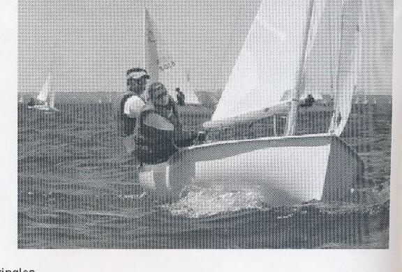 Crew rigging a boat at the dock