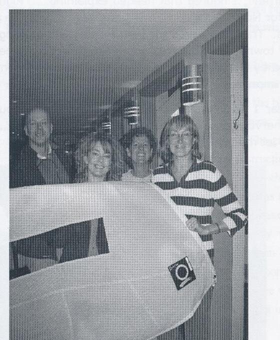 Four sailors posing together indoors