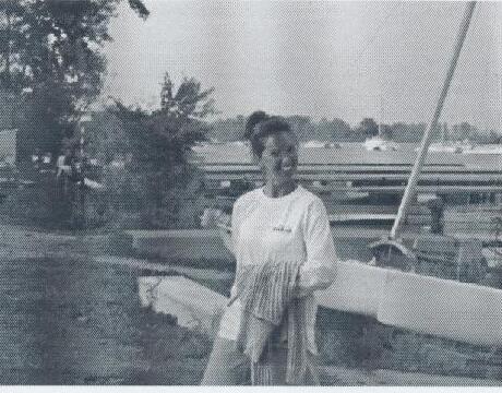 Commodore Teresa Miolla standing beside an Albacore