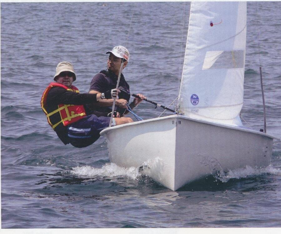 An Albacore crew hiking hard on a reach