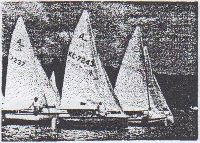 Three Albacores, including KC 7243, sailing close together towards the windward mark